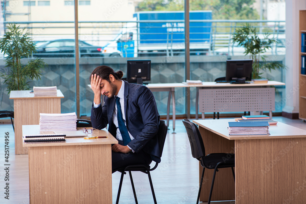 Young male employee working in the office