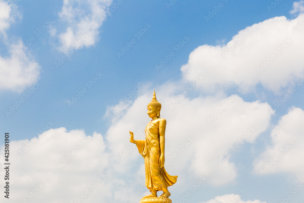 Fototapeta premium The standing buddha with blue sky and cloud,Copy space
