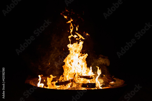wood fire in a big cement bowl at the beach