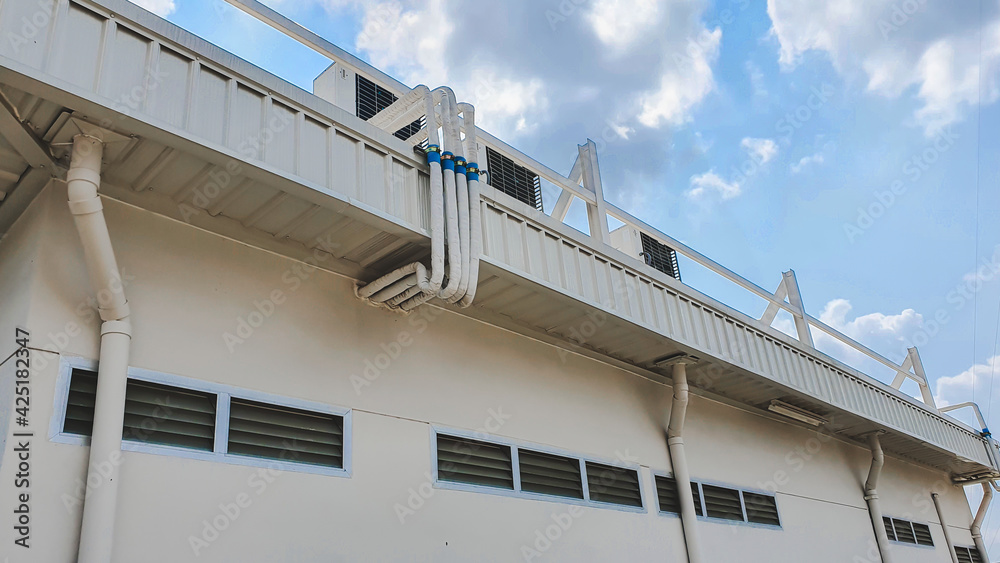 Fototapeta premium metal roof panel with blue sky and white clouds in the background.