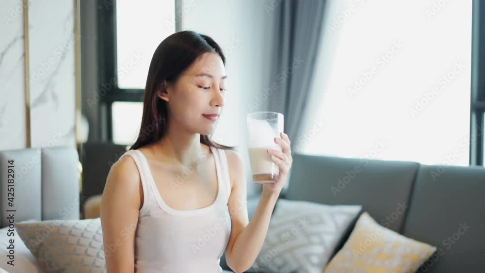 Asian young woman drinking milk.Beautiful Asian pregnant woman drink milk then smile and also looking at camera. Asian young woman drinking milk.Beautiful Asian pregnant woman drink milk then smile and also looking at camera.