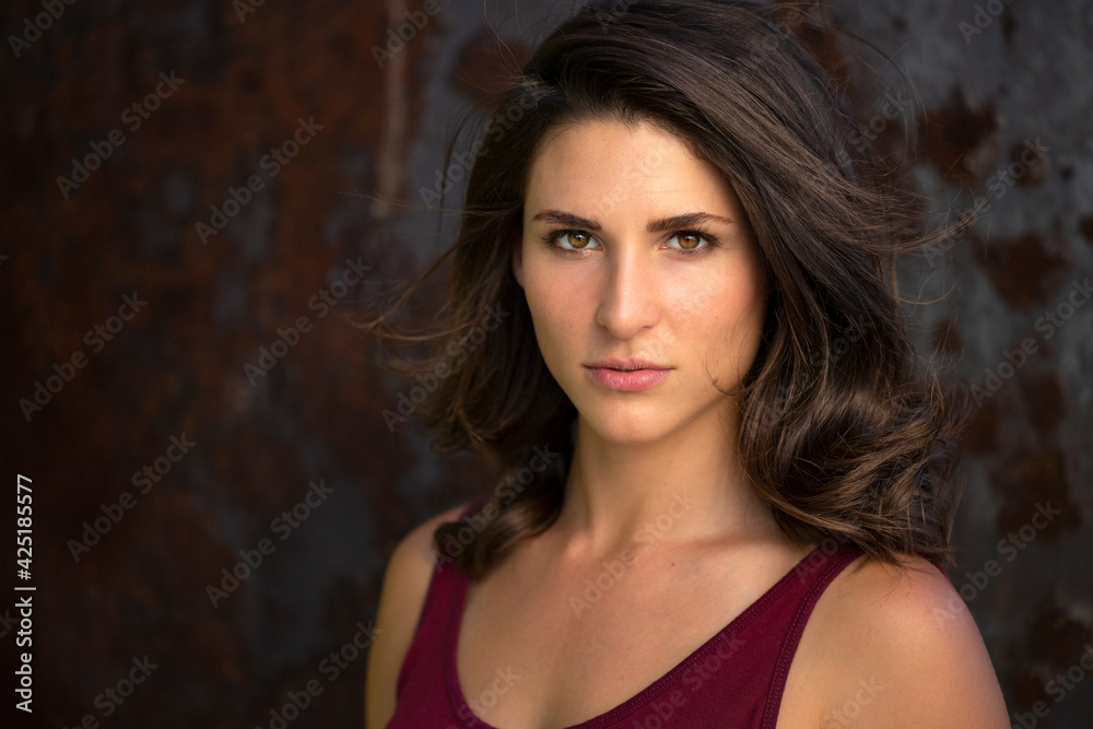 Beautiful portrait head shot of a serious and confident pretty brunette woman with an empowered strong passionate gaze Beautiful portrait head shot of a serious and confident pretty brunette woman with an empowered strong passionate gaze