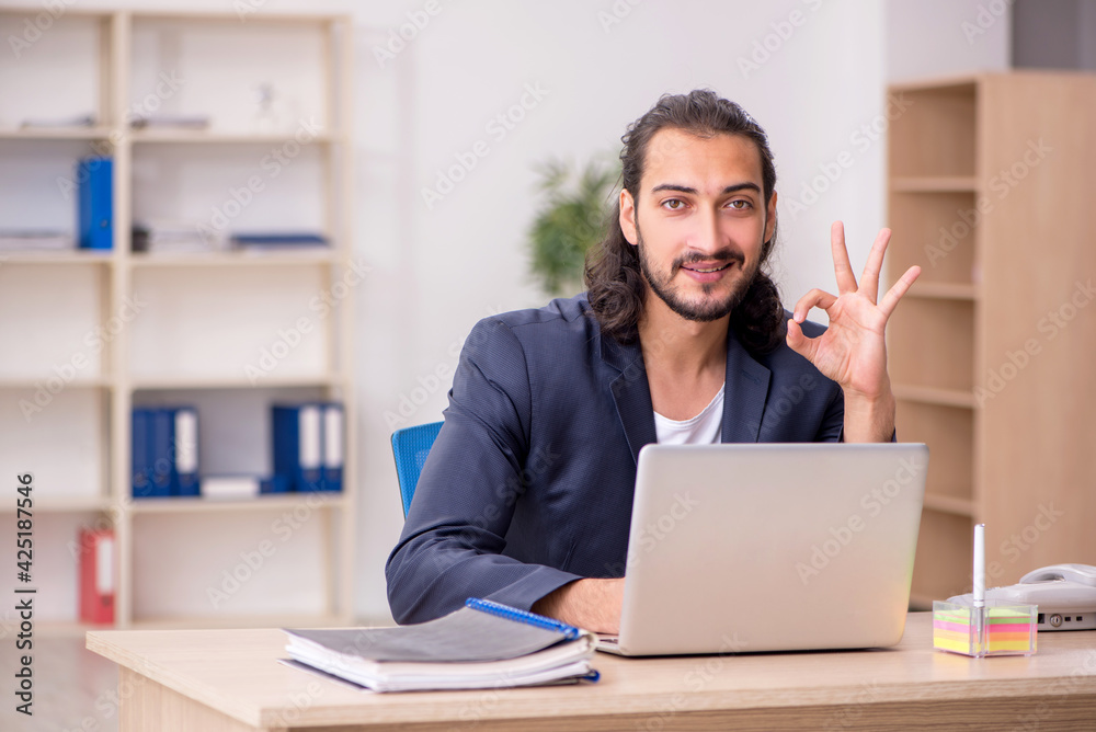 Young male employee working in the office Young male employee working in the office