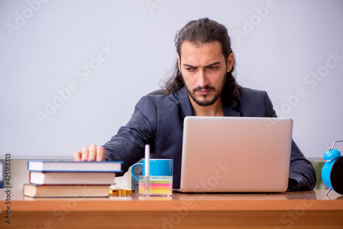 Young male teacher in the classroom