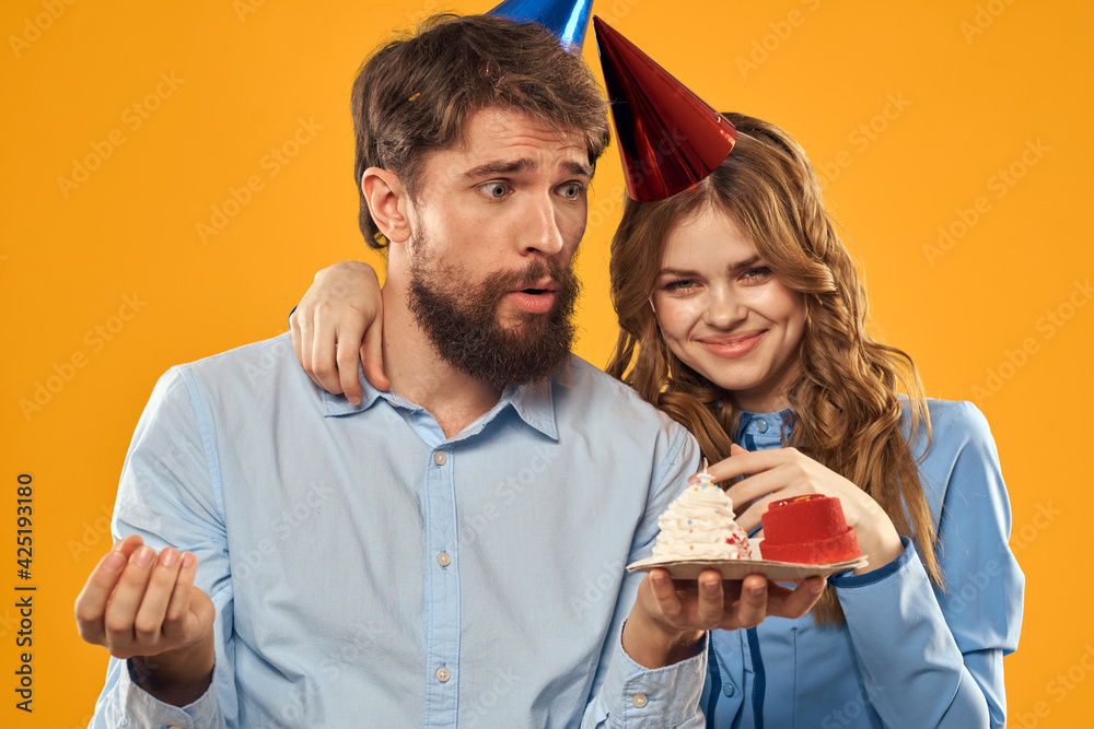 Birthday party man and woman fun yellow background cap holiday Birthday party man and woman fun yellow background cap holiday