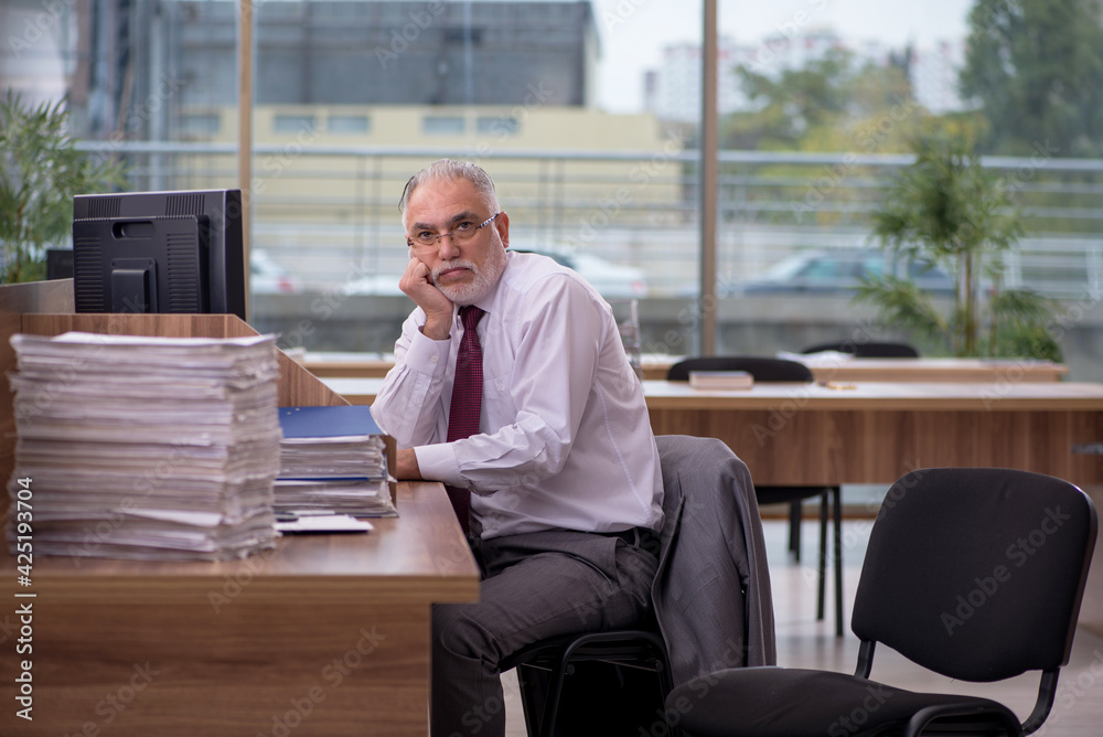 Old businessman employee and too much work in the office Old businessman employee and too much work in the office