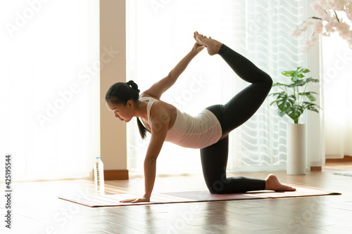 Asian woman pilates exercise yoga in home.