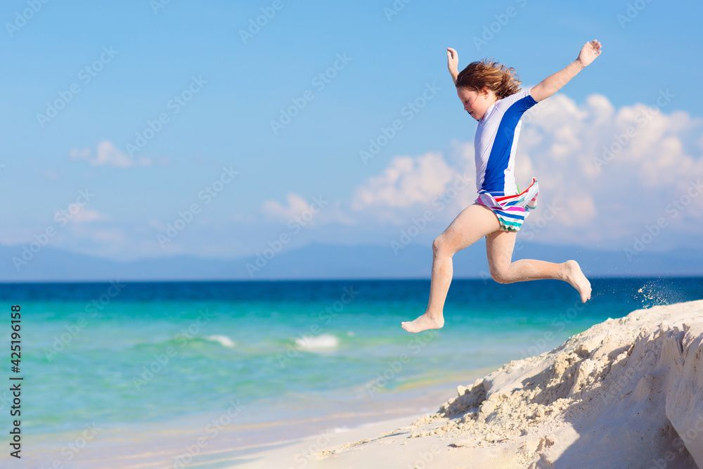 Kids playing on beach. Children play at sea.