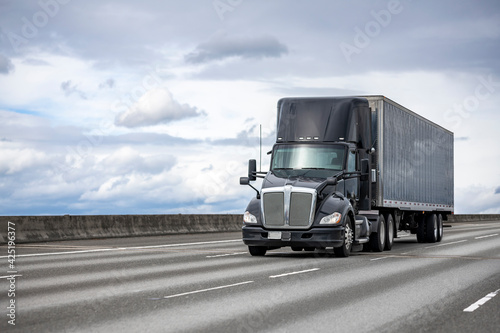 Εκτύπωση καμβά Powerful stylish black big rig day cab semi truck deliver commercial cargo in co