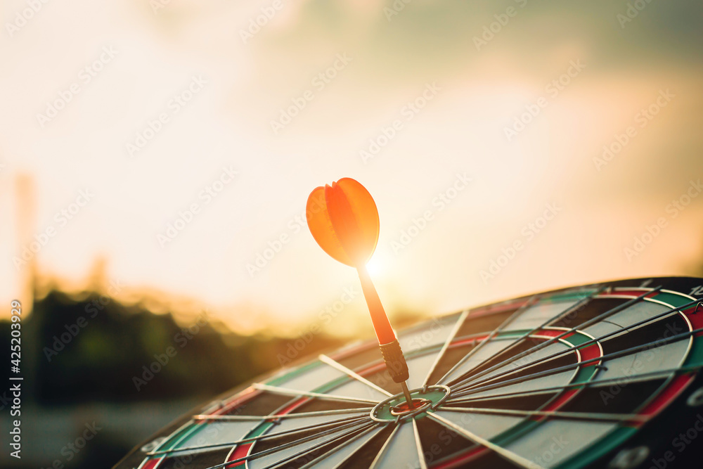 Close up shot of the dart arrow hit on bulleyes of dartboard to business. Dart is an opportunity and Dartboard is the target and goal. Close up shot of the dart arrow hit on bulleyes of dartboard to business. Dart is an opportunity and Dartboard is the target and goal.