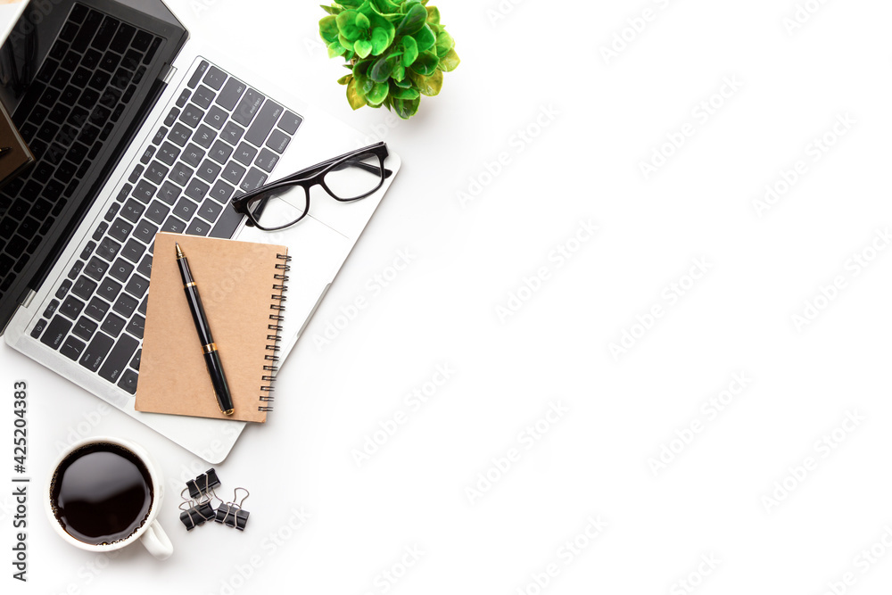 Flat lay, top view office table desk. Workspace with, laptop,office supplies, pencil, green leaf, and coffee cup on white background. Flat lay, top view office table desk. Workspace with, laptop,office supplies, pencil, green leaf, and coffee cup on white background.