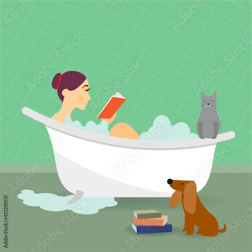 Young woman in bath tub reading a book