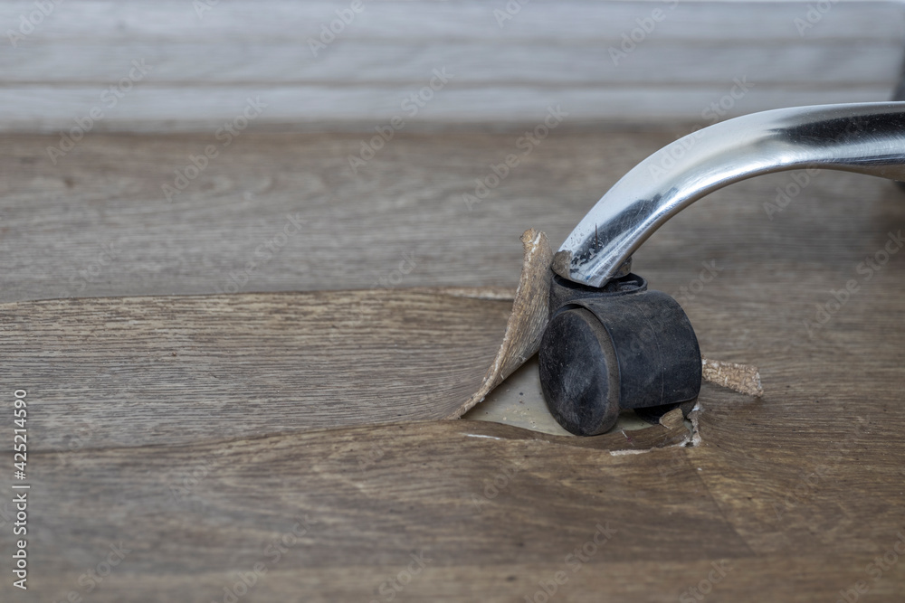 Obraz premium Damaged Linoleum floor covering by office chair wheels.