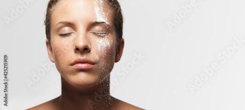 young woman loose powder on her face