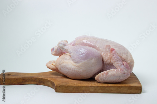 Chicken carcass on a white background. Chicken meat on a wooden board. Diet meat.