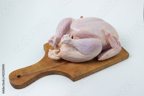 Chicken carcass on a white background. Chicken meat on a wooden board. Diet meat.