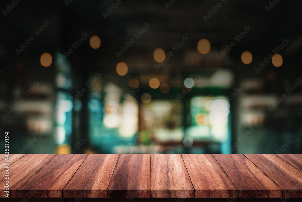 Empty of wood table with blur cafe or coffee shop background.