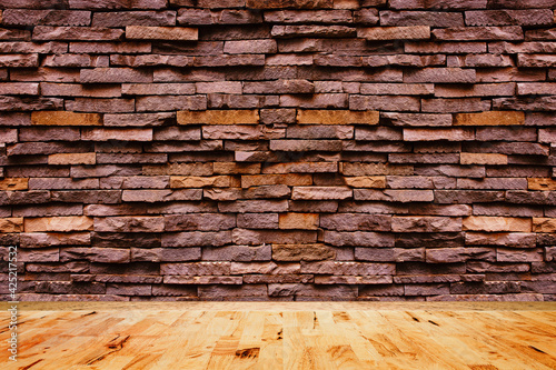 Empty wood floor texture with decorative stone wall background.