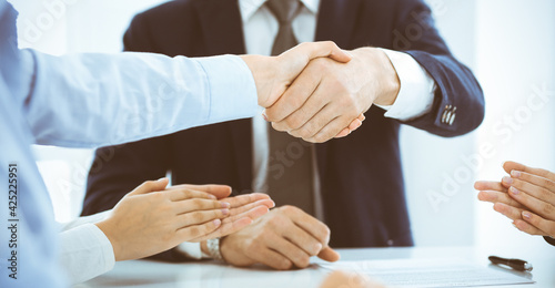 Business people or lawyers shaking hands finishing up a meeting, close-up. Negotiation and handshake concepts