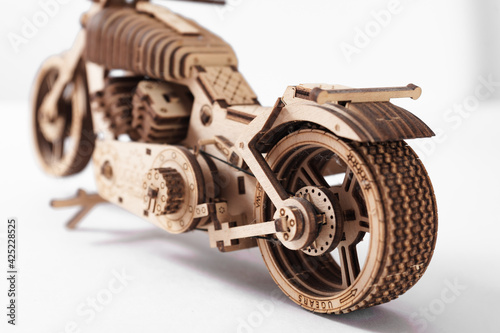 Wooden toy-motorcycle designer on a white background