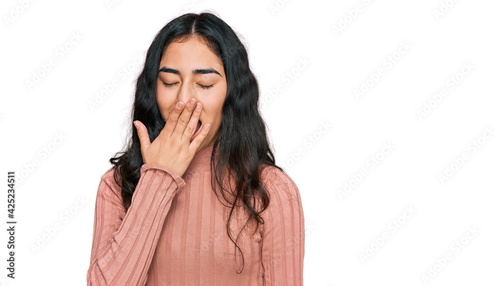 Hispanic teenager girl with dental braces wearing casual clothes bored yawning tired covering mouth with hand. restless and sleepiness. Hispanic teenager girl with dental braces wearing casual clothes bored yawning tired covering mouth with hand. restless and sleepiness.