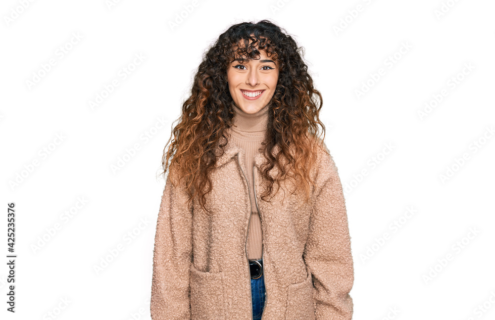 Young hispanic girl wearing winter clothes with a happy and cool smile on face. lucky person. Young hispanic girl wearing winter clothes with a happy and cool smile on face. lucky person.