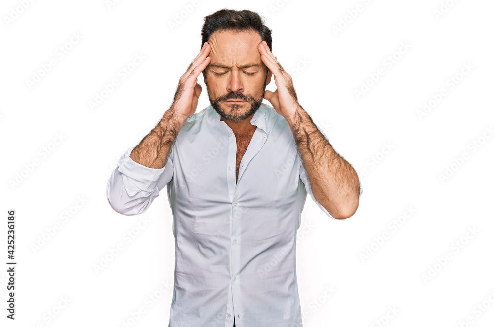 Middle age man wearing casual clothes with hand on head for pain in head because stress. suffering migraine. Middle age man wearing casual clothes with hand on head for pain in head because stress. suffering migraine.