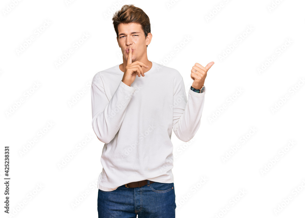 Handsome caucasian man wearing casual white sweater asking to be quiet with finger on lips pointing with hand to the side. silence and secret concept. Handsome caucasian man wearing casual white sweater asking to be quiet with finger on lips pointing with hand to the side. silence and secret concept.