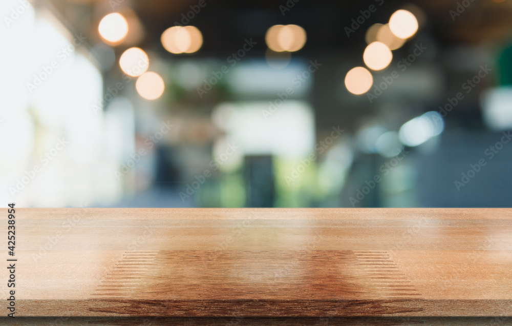 Empty wooden table top with lights bokeh on blur restaurant background. Empty wooden table top with lights bokeh on blur restaurant background.