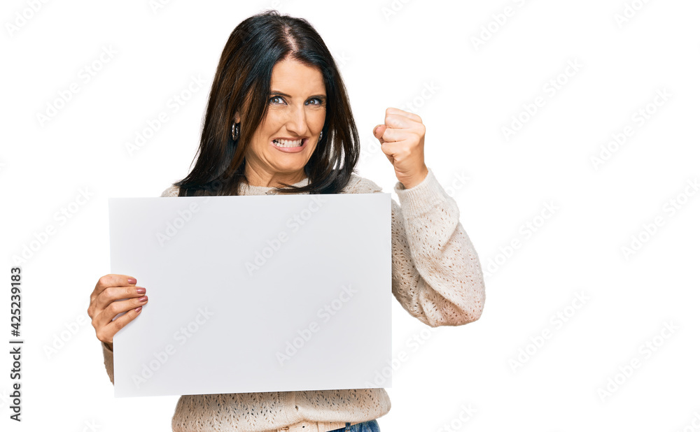 Middle age brunette woman holding blank empty banner annoyed and frustrated shouting with anger, yelling crazy with anger and hand raised Middle age brunette woman holding blank empty banner annoyed and frustrated shouting with anger, yelling crazy with anger and hand raised