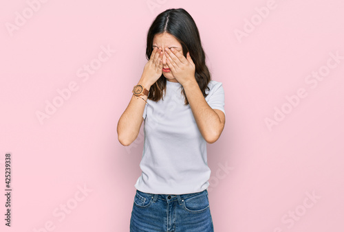 Young beautiful woman wearing casual white t shirt rubbing eyes for fatigue and headache, sleepy and tired expression. vision problem
