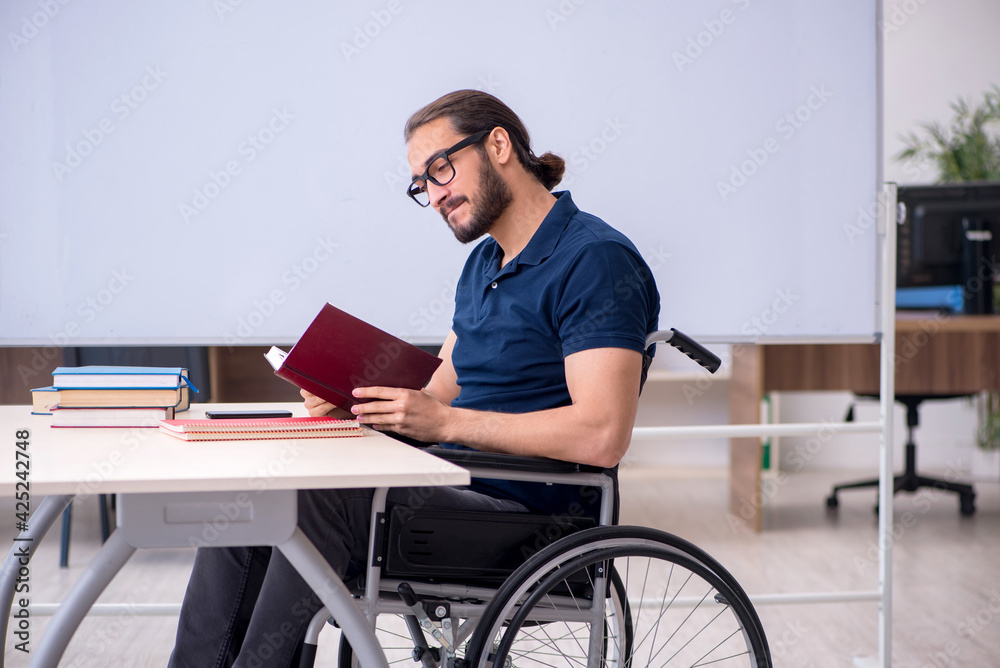 Young male handicapped student in the classroom Young male handicapped student in the classroom