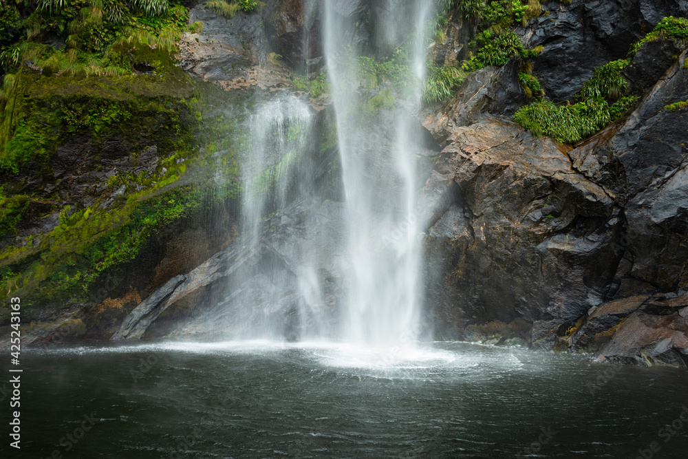 Obraz premium Base of Fairy Falls with radiant patterns caused by the force of the free-fall water, Milford Sound.