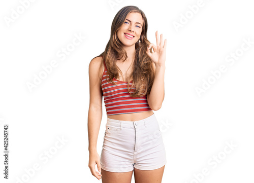 Beautiful caucasian young woman wearing casual clothes smiling positive doing ok sign with hand and fingers. successful expression.