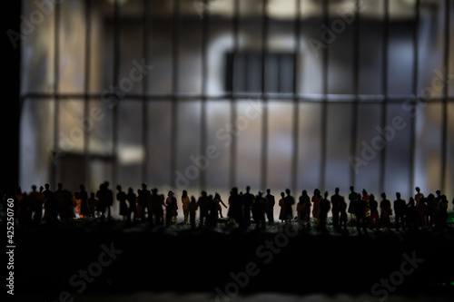 People and police government power concept. Crowd looking on big handcuffs at night with fog and backlight. Creative artwork decoration. Selective focus.