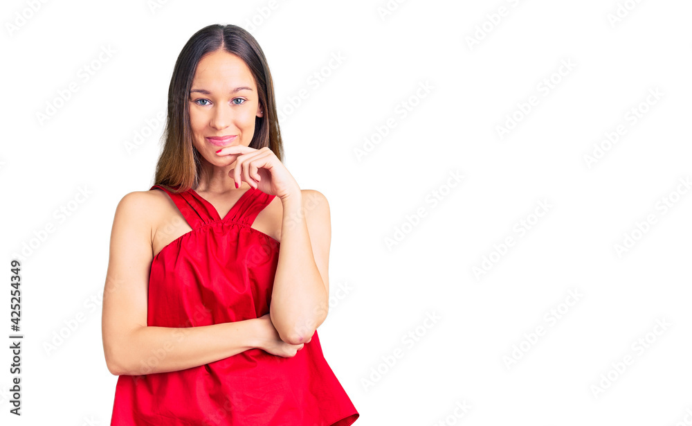 Beautiful brunette young woman wearing casual clothes looking confident at the camera with smile with crossed arms and hand raised on chin. thinking positive. Beautiful brunette young woman wearing casual clothes looking confident at the camera with smile with crossed arms and hand raised on chin. thinking positive.