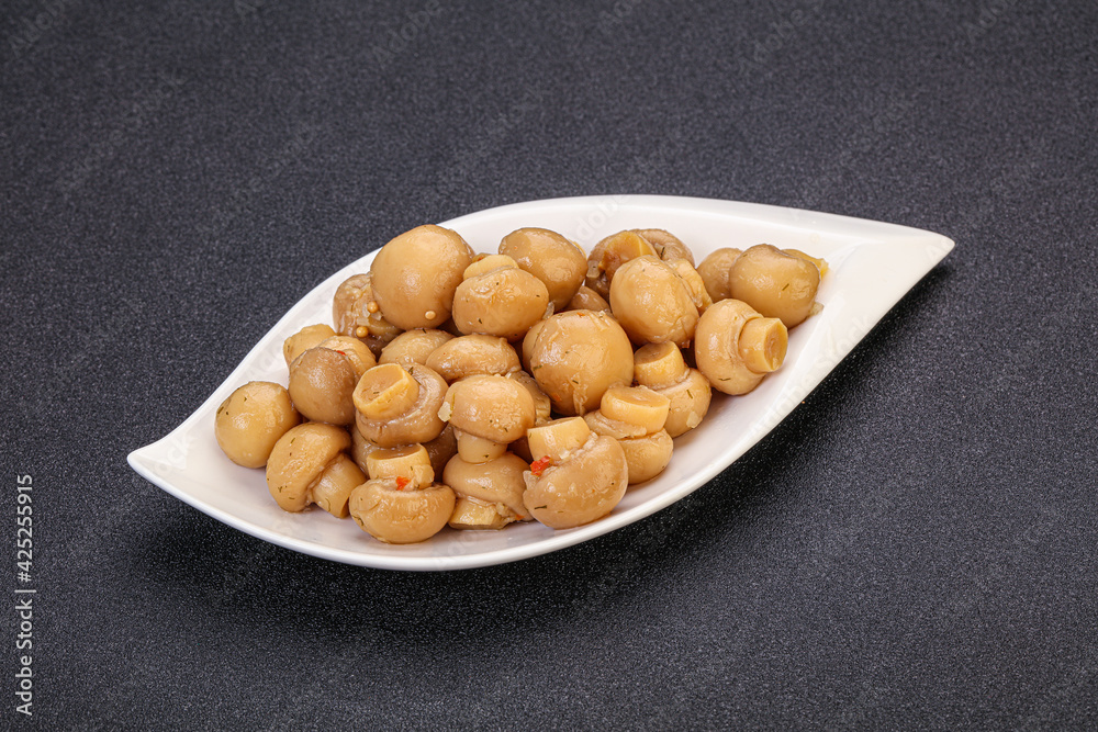 Pickled champignons in the bowl Pickled champignons in the bowl