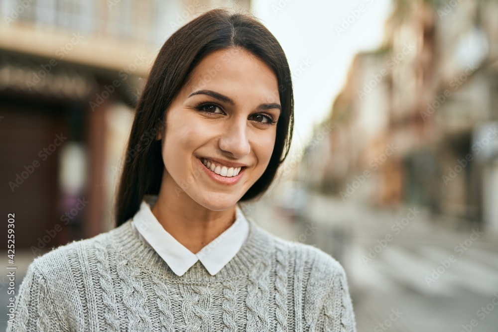 Young hispanic woman smiling happy standing at the city. Young hispanic woman smiling happy standing at the city.