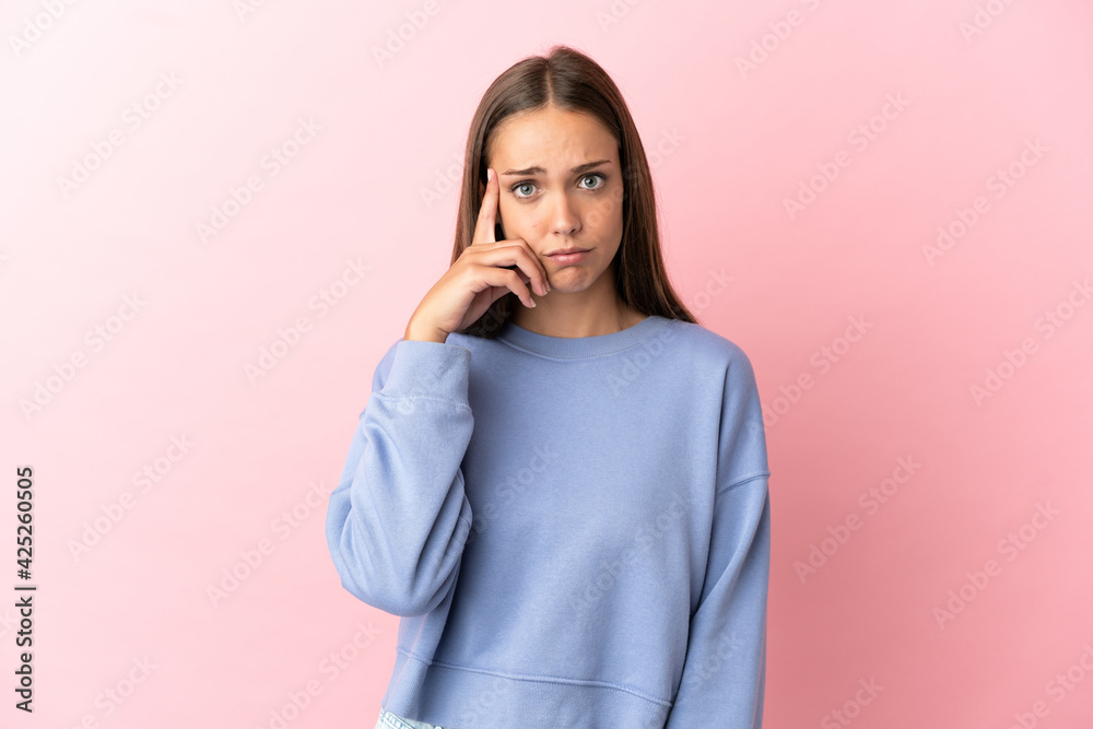 Young woman over isolated pink background thinking an idea Young woman over isolated pink background thinking an idea