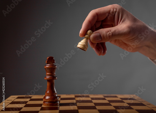 Business strategy concept. Pawn making final last step to make checkmate in chess photo