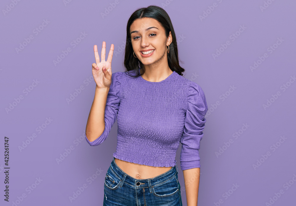 Young hispanic girl wearing casual clothes showing and pointing up with fingers number three while smiling confident and happy. Young hispanic girl wearing casual clothes showing and pointing up with fingers number three while smiling confident and happy.