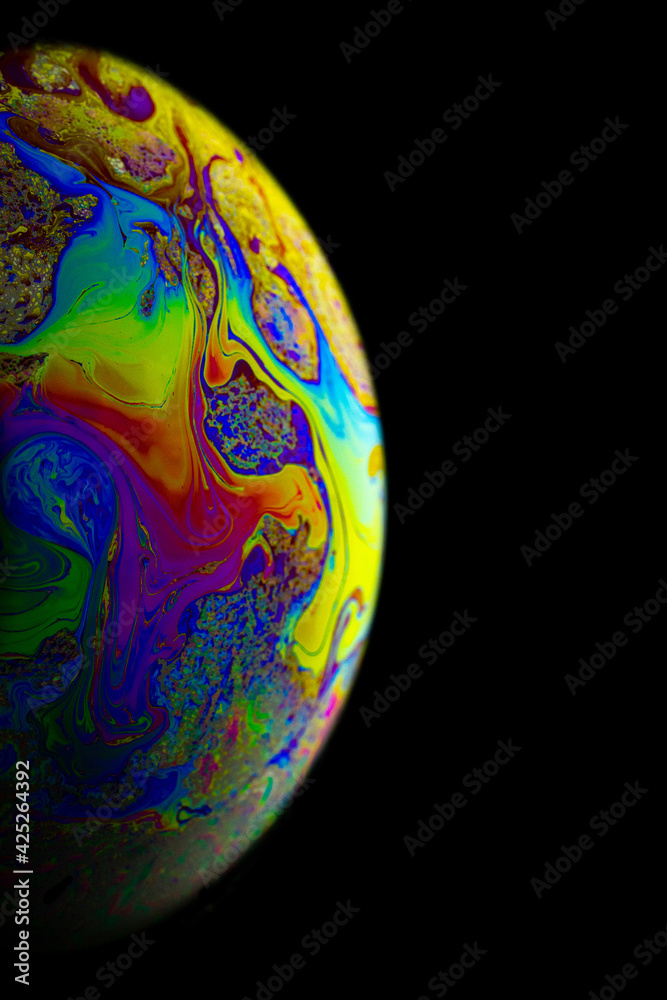 Space galaxy planet. Globe earth in galaxy universe with abstract sun on black background. Color abstract fluorescent inks in water.