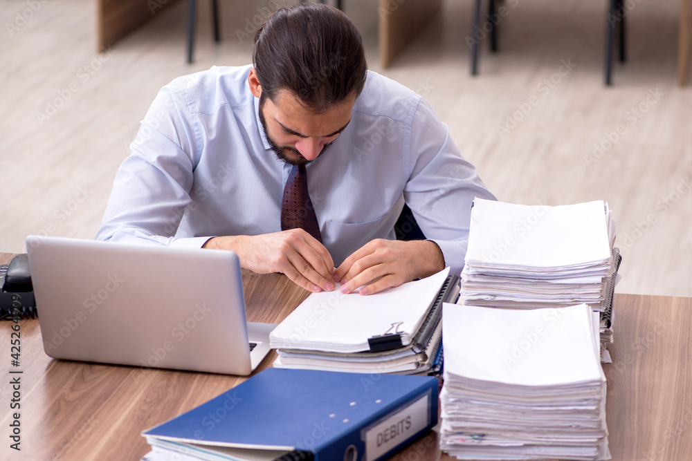 Young businessman employee unhappy with excessive work in the of Young businessman employee unhappy with excessive work in the of