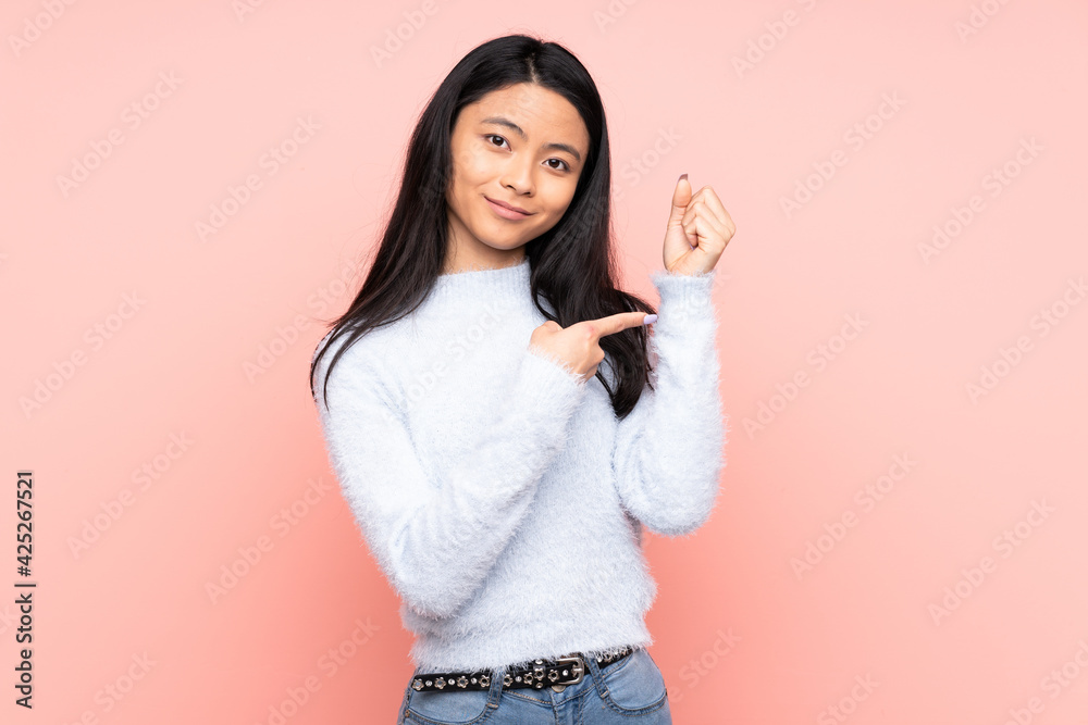 Teenager Chinese woman isolated on pink background making the gesture of being late Teenager Chinese woman isolated on pink background making the gesture of being late