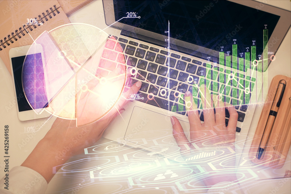 Double exposure of woman hands working on computer and forex graph hologram drawing. Top View. Financial analysis concept. Double exposure of woman hands working on computer and forex graph hologram drawing. Top View. Financial analysis concept.