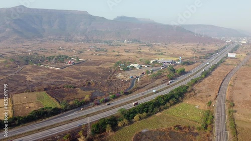 Aerial view of the Mumbai Pune Expressway along with the Mumbai Pune railway line at Kamshet near Pune India. photo