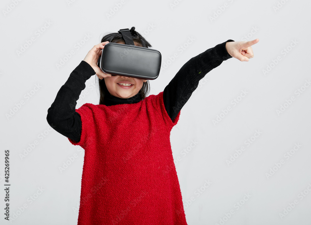 Cute Asian little girl playing with VR glasses Cute Asian little girl playing with VR glasses