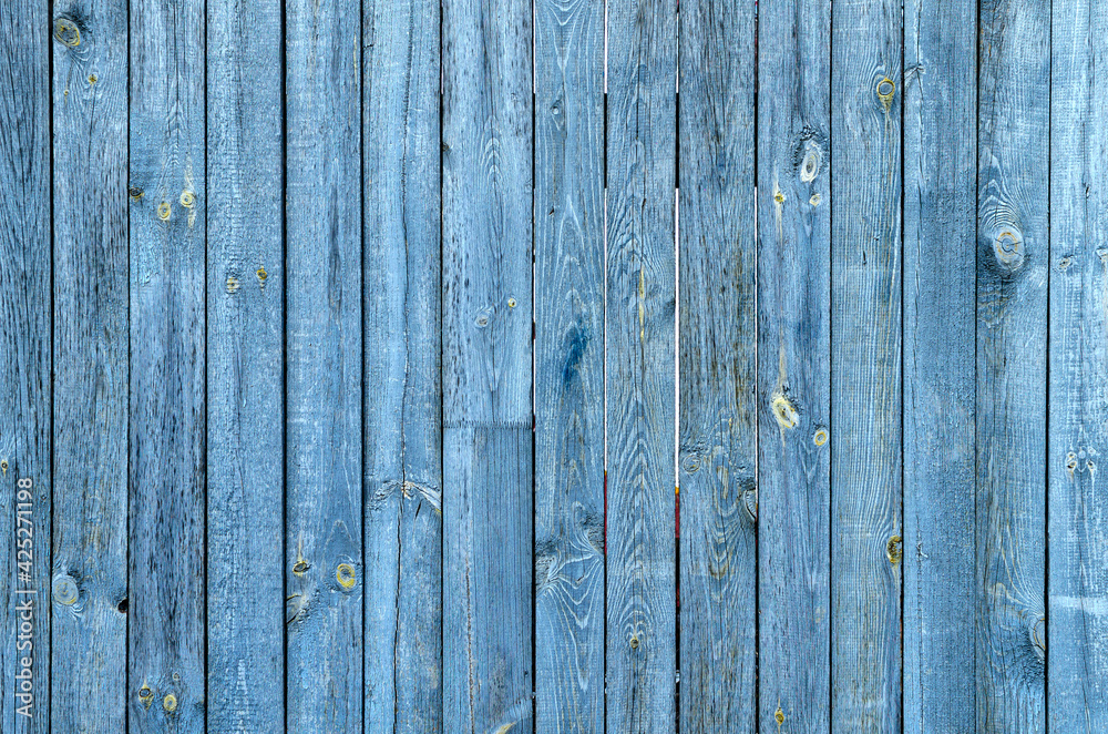 Naklejka premium blue wood background with peeled paint, fencing with old wood planks