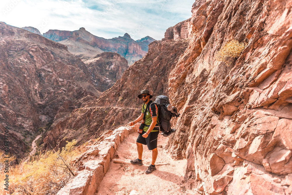 A young man on the ascent of the Bright Angel Trailhead in the Grand Canyon. Arizona
