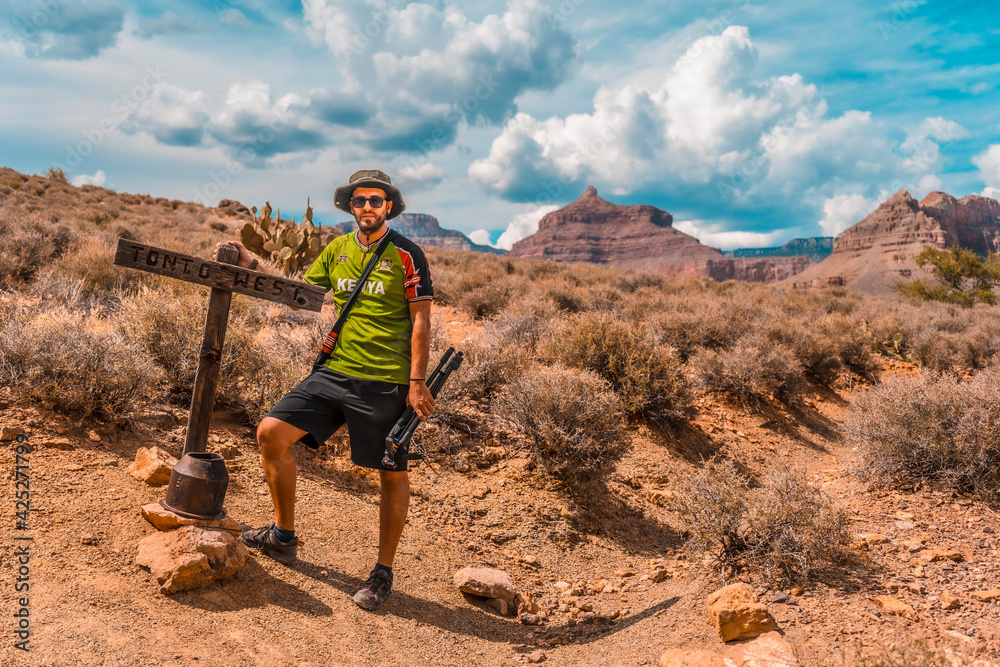 A young man walking along the Bright Angel Trailhead at the Tonto West turnoff, in the Grand Canyon. Arizona.